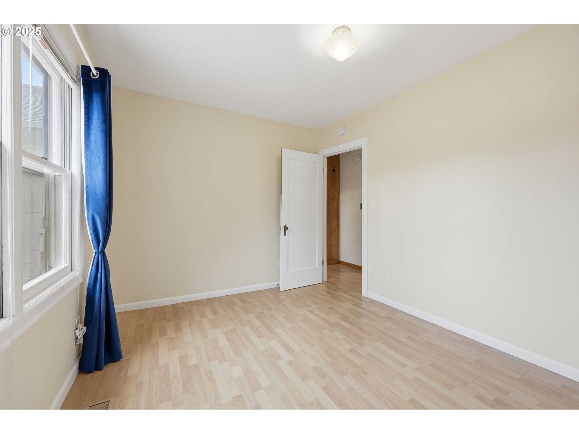 11040 Southeast McCreary Lane Boring, OR 97009 - Photo 21 of 38 a view of an empty room with wooden floor and a window