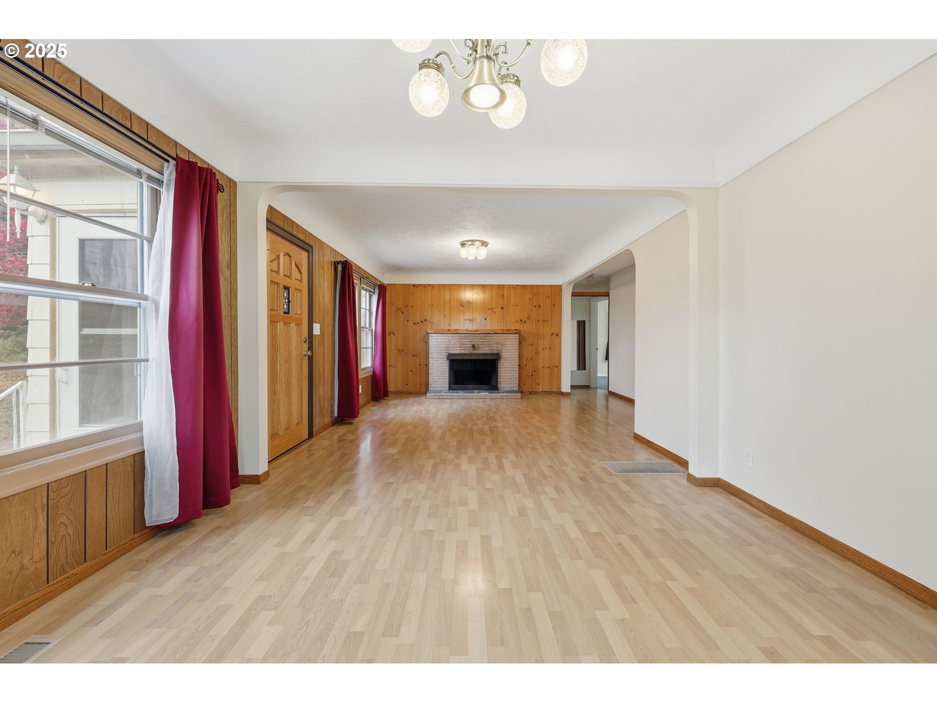 11040 Southeast McCreary Lane Boring, OR 97009 - Photo 6 of 38 a empty room with a fireplace and wooden floor