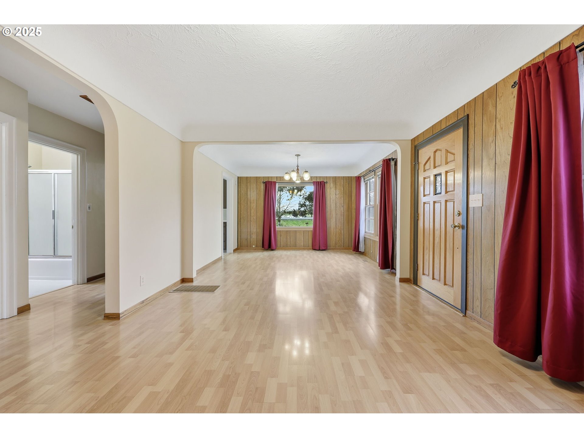 11040 Southeast McCreary Lane Boring, OR 97009 - Photo 7 of 38 a view of an empty room with wooden floor and a window