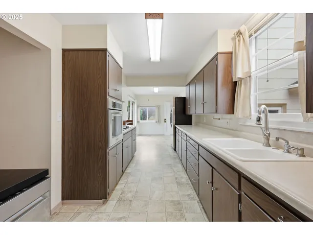 a kitchen with a sink and refrigerator