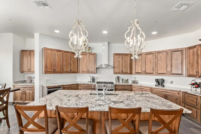 a living room with furniture kitchen and a large window