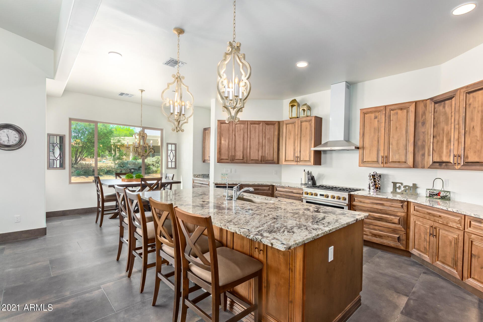 27808 Desierto Drive Rio Verde, AZ 85263 - Photo 13 of 42 a kitchen with a table chairs stove and cabinets