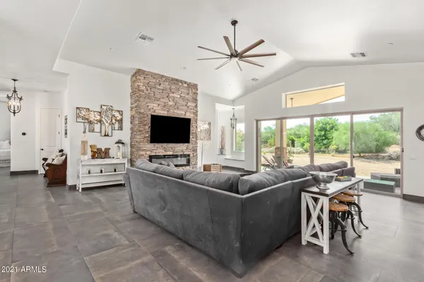 a living room with furniture a flat screen tv and a window