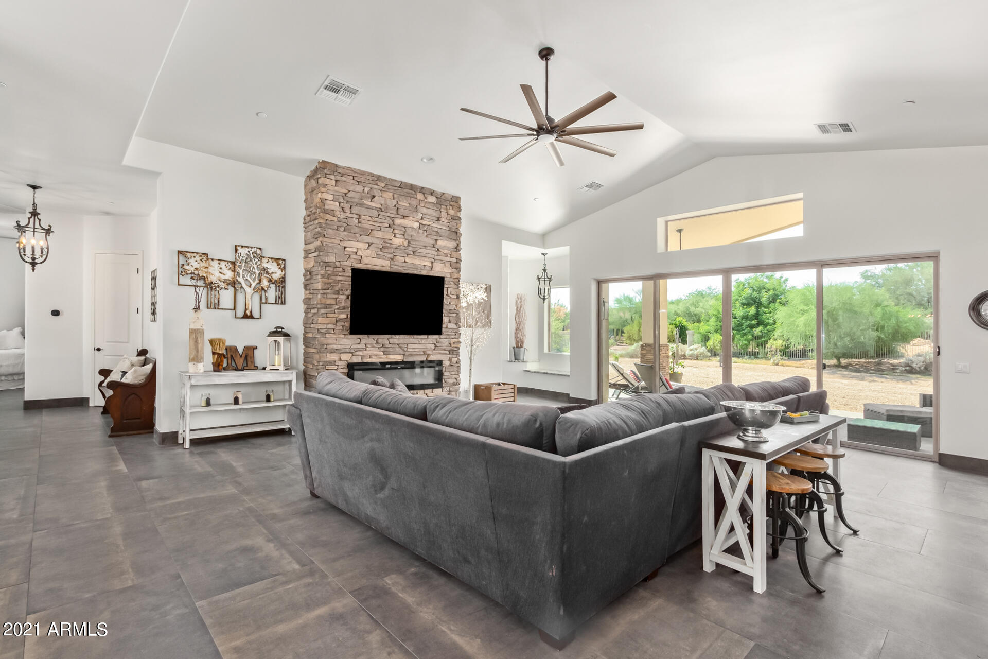 27808 Desierto Drive Rio Verde, AZ 85263 - Photo 17 of 42 a living room with furniture a flat screen tv and a large window