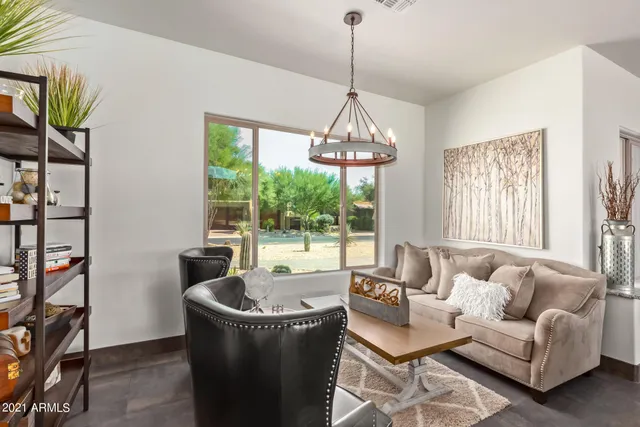 a living room with furniture a flat screen tv and a large window