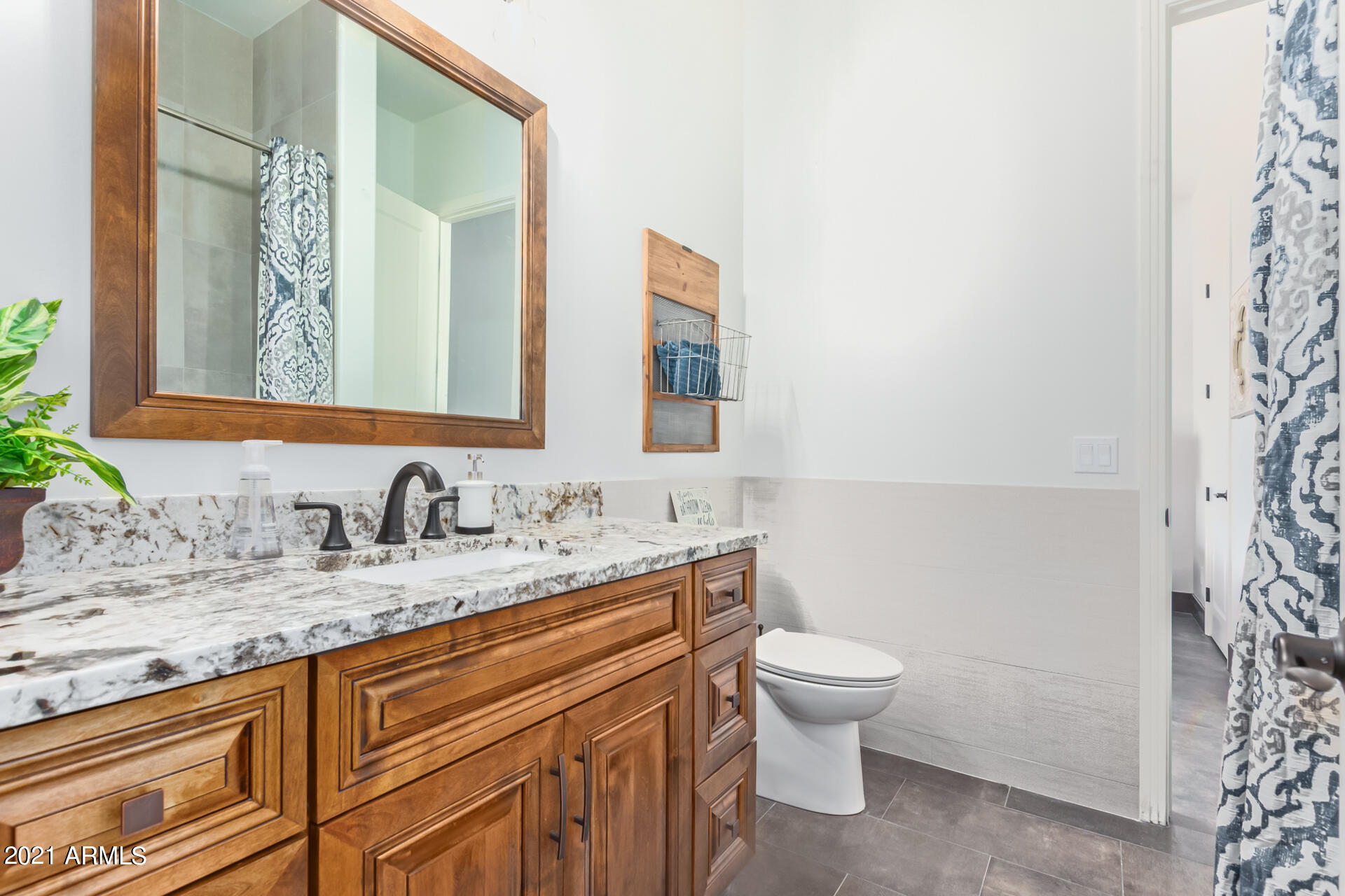 27808 Desierto Drive Rio Verde, AZ 85263 - Photo 27 of 42 a bathroom with a granite countertop sink a toilet and a mirror