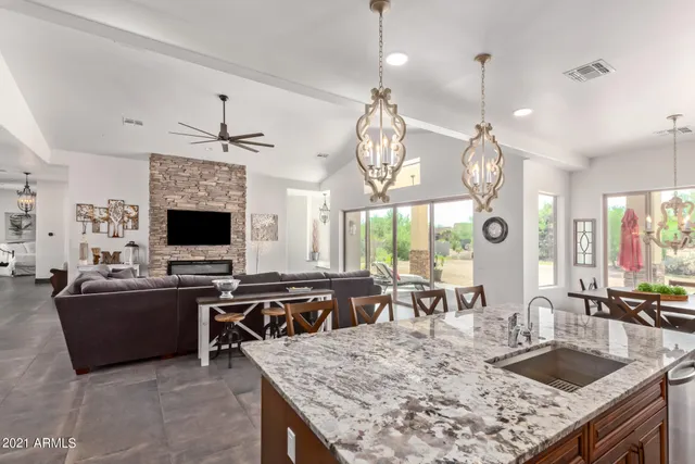 a large kitchen with a table and chairs