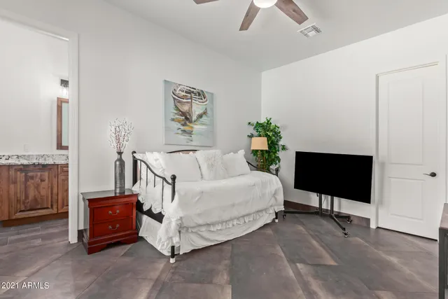 a bedroom with a bed and a night stand