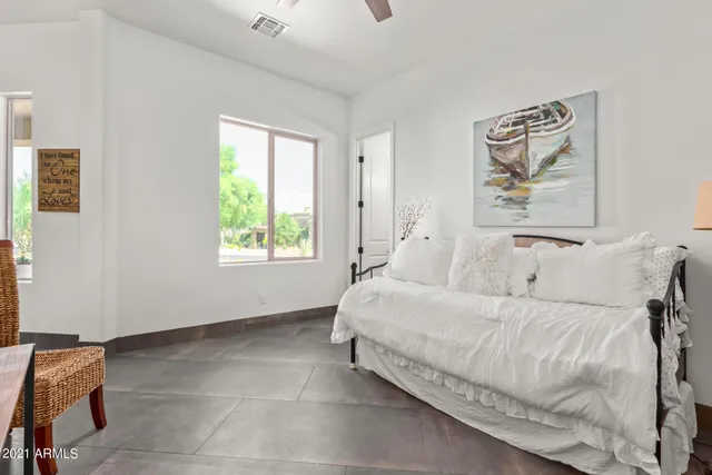 a large bed sitting in a bedroom next to a window