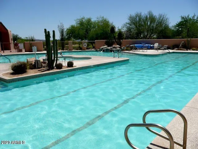 a view of swimming pool with outdoor seating and plants
