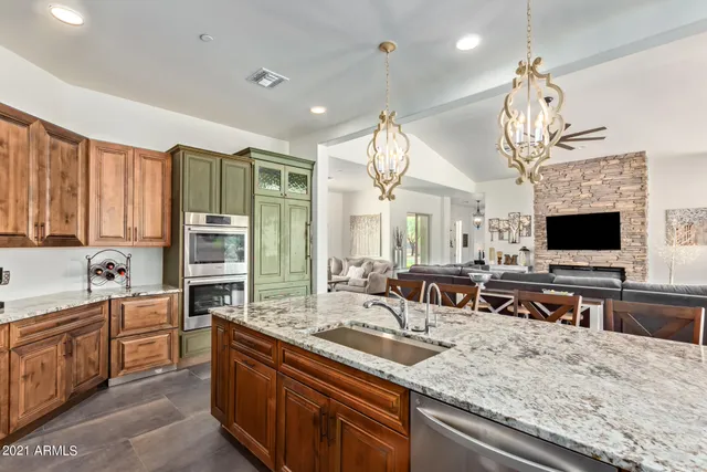 a kitchen with stainless steel appliances a stove sink and cabinets