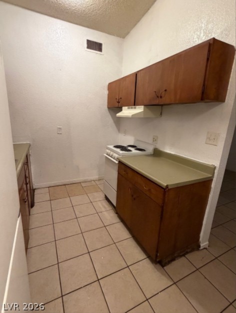 521 North Decatur Boulevard, Unit B Las Vegas, NV 89107 - Photo 7 of 17 Compact and practical, this kitchen offers essential amenities for everyday living.
