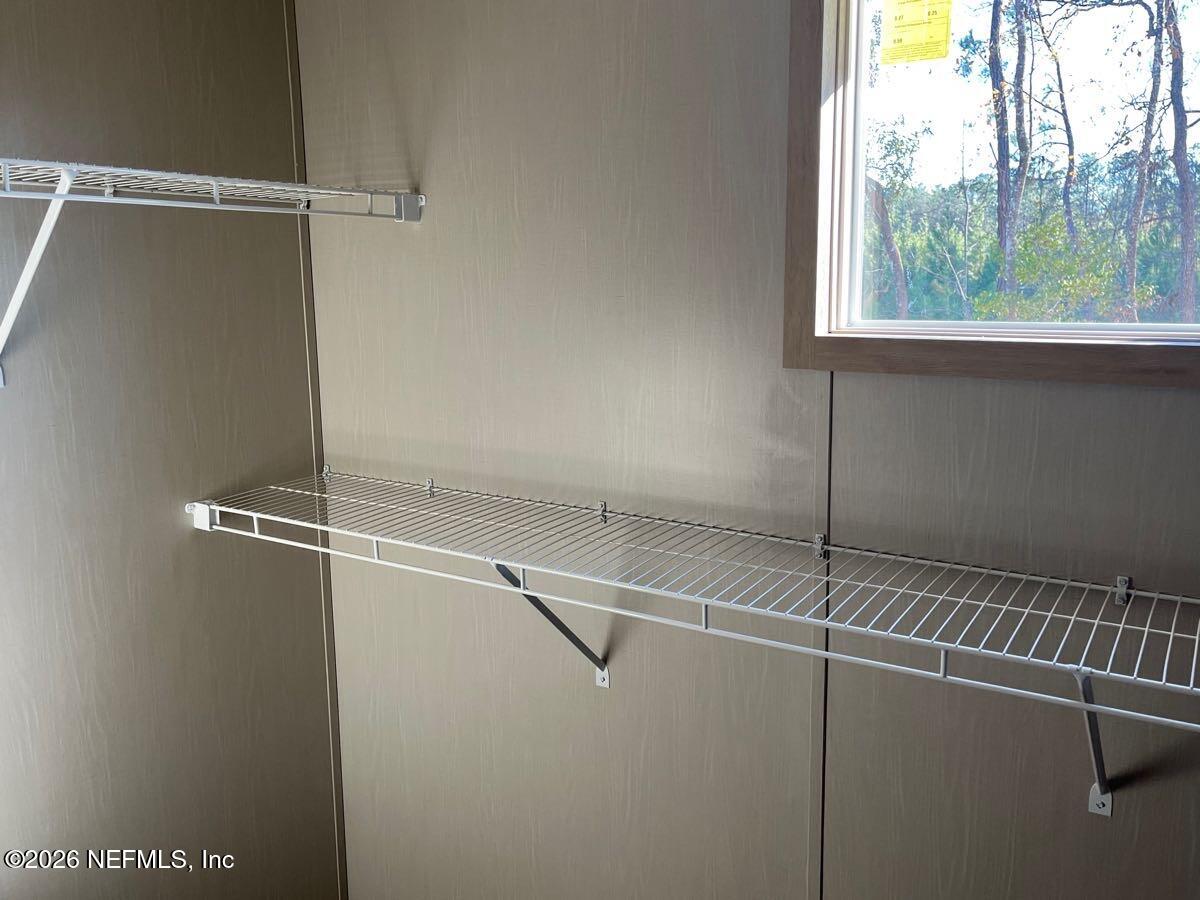 28711 Tracy Road Hilliard, FL 32046 - Photo 11 of 33 a view of a room with rack on the wall and a window