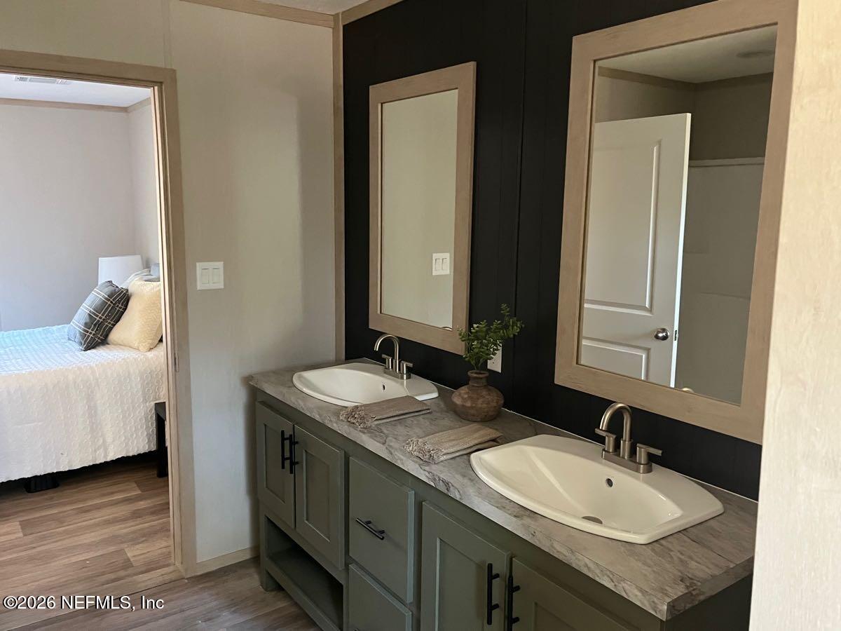 28711 Tracy Road Hilliard, FL 32046 - Photo 14 of 33 a en suite bathroom with a sink and a mirror