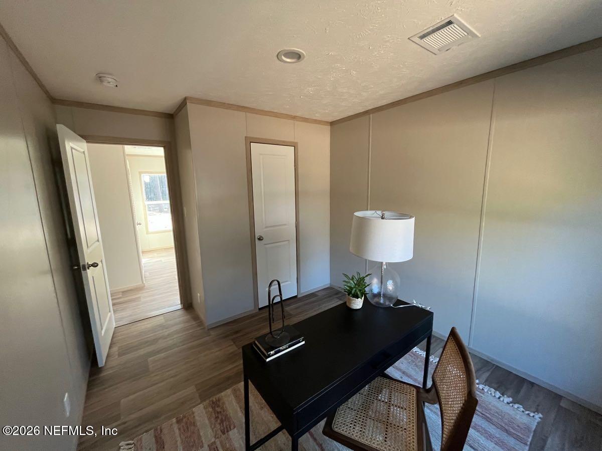 28711 Tracy Road Hilliard, FL 32046 - Photo 19 of 33 a living room with furniture and a window