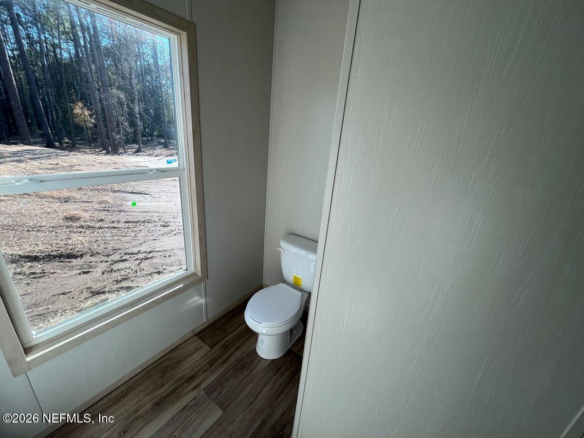 28711 Tracy Road Hilliard, FL 32046 - Photo 21 of 33 a bathroom with a toilet and a shower