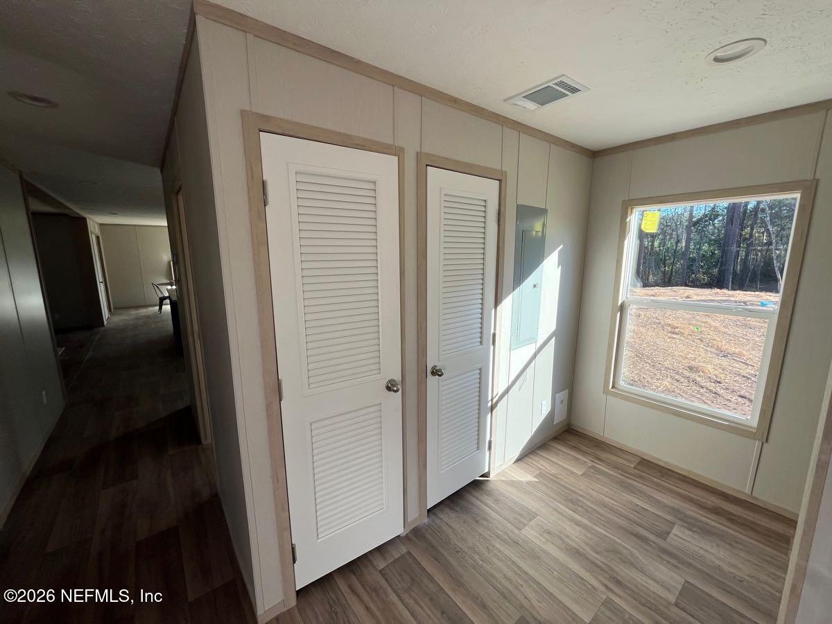 28711 Tracy Road Hilliard, FL 32046 - Photo 25 of 33 a view of an empty room with wooden floor and a window
