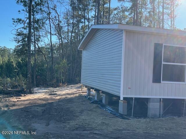 28711 Tracy Road Hilliard, FL 32046 - Photo 29 of 33 a view of wooden house with large trees