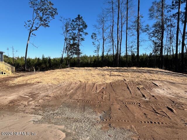 28711 Tracy Road Hilliard, FL 32046 - Photo 30 of 33 a view of empty space with wooden fence