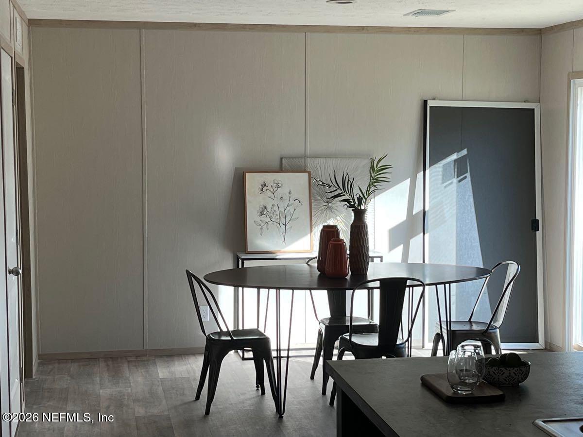 28711 Tracy Road Hilliard, FL 32046 - Photo 8 of 33 a table and chairs in a room