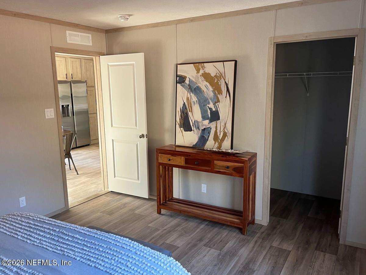 28711 Tracy Road Hilliard, FL 32046 - Photo 10 of 33 a view of a livingroom with wooden floor and a fireplace