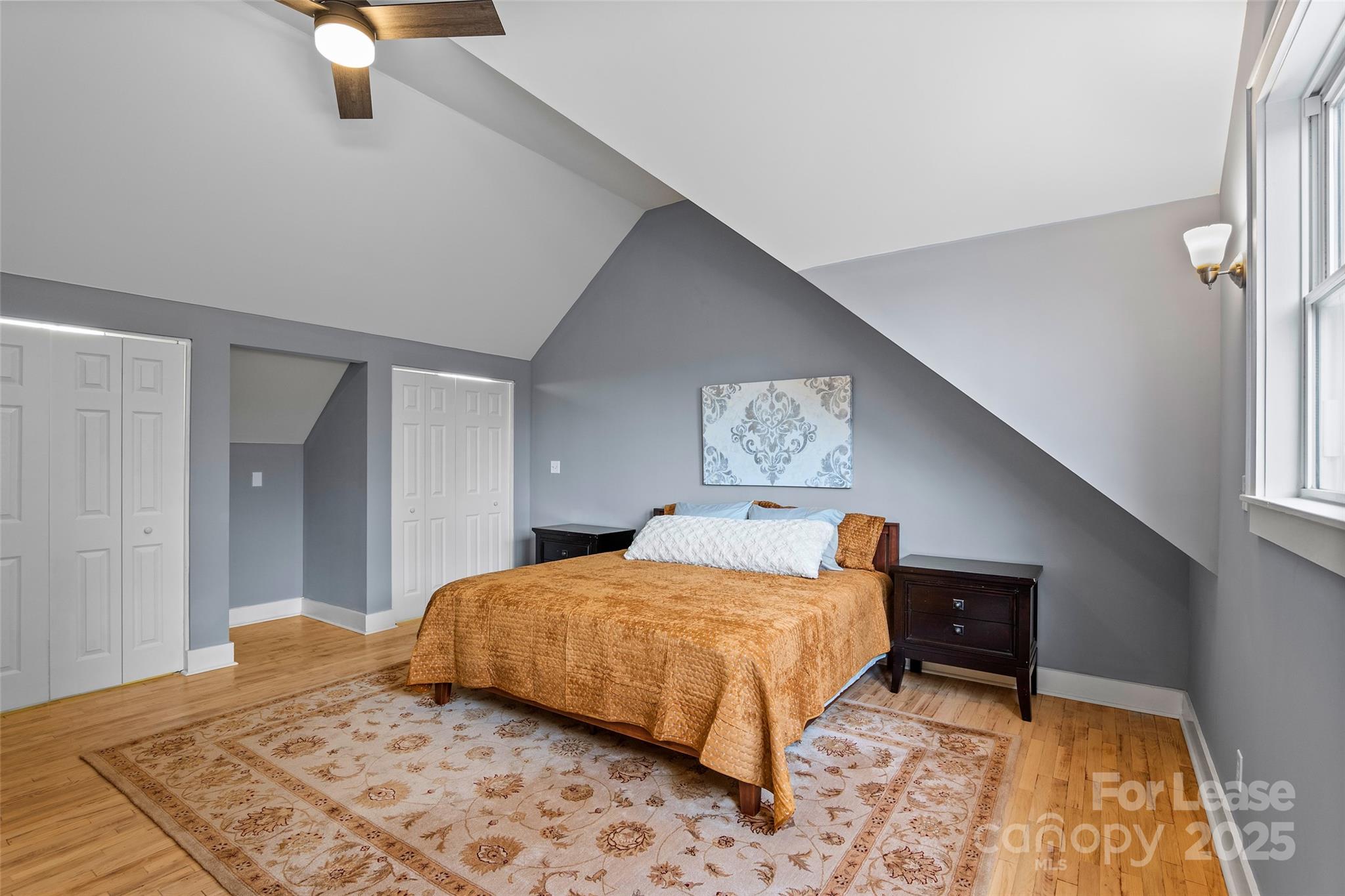 5 Elmore Street Asheville, NC 28804 - Photo 13 of 37 a bedroom with a bed and a lamp on dresser