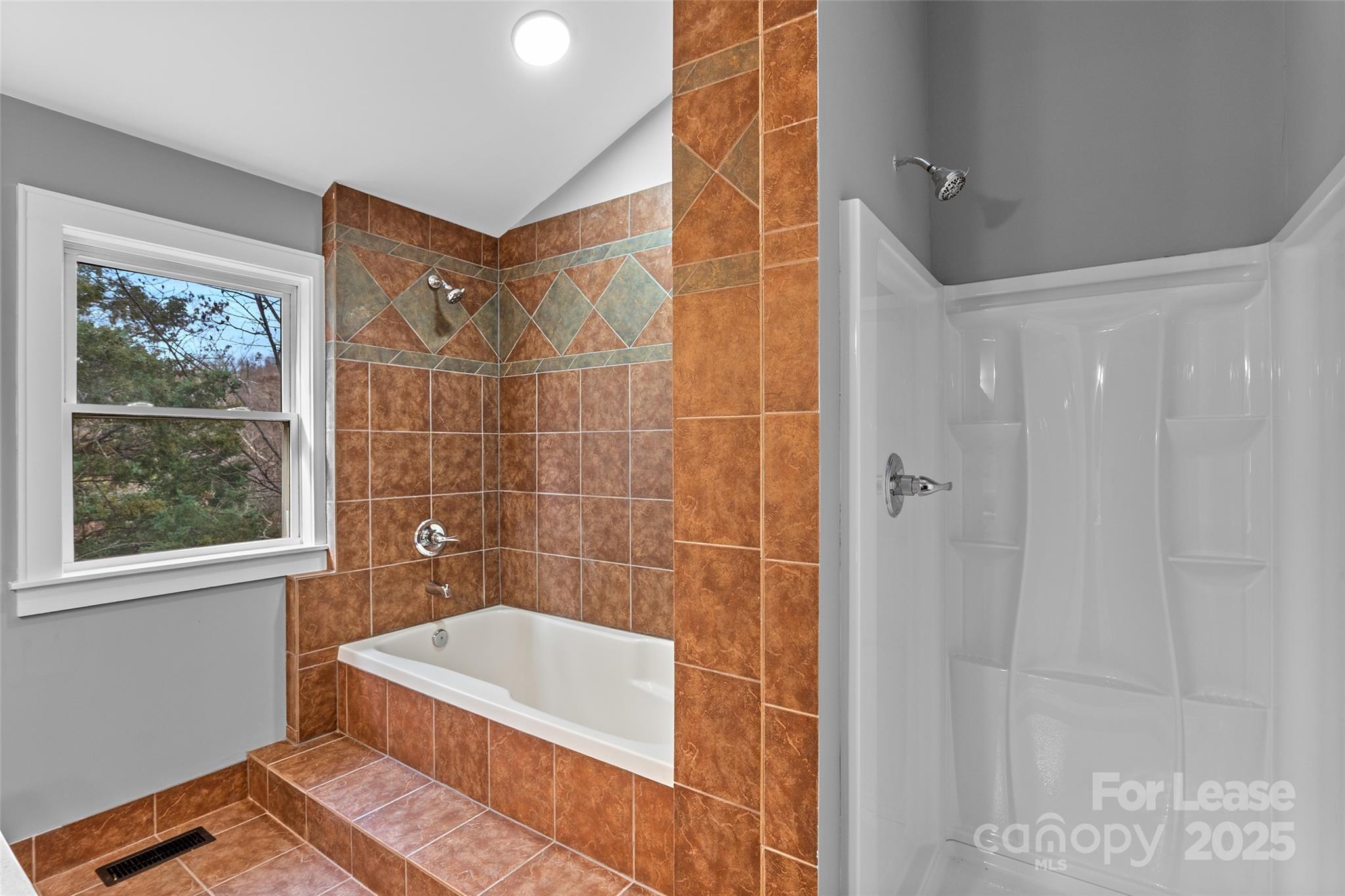 5 Elmore Street Asheville, NC 28804 - Photo 17 of 37 a bathroom with a tub a window and a shower