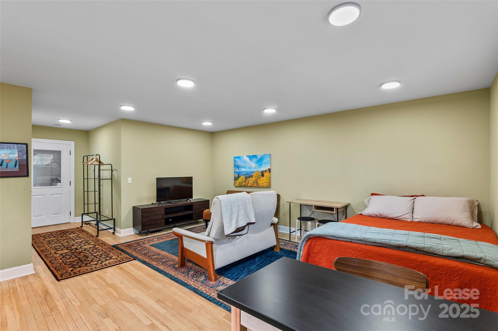 5 Elmore Street Asheville, NC 28804 - Photo 23 of 37 a bedroom with a bed and a laptop on desk