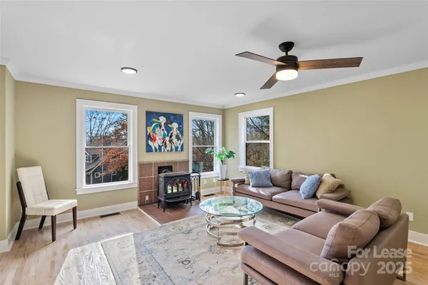 a living room with furniture a rug and a window