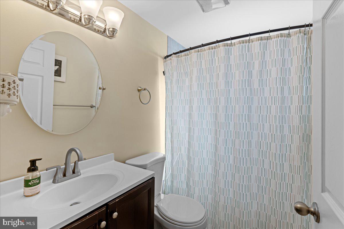 142 Pheasant Lane Willingboro, NJ 08046 - Photo 17 of 24 a bathroom with a sink vanity mirror and toilet