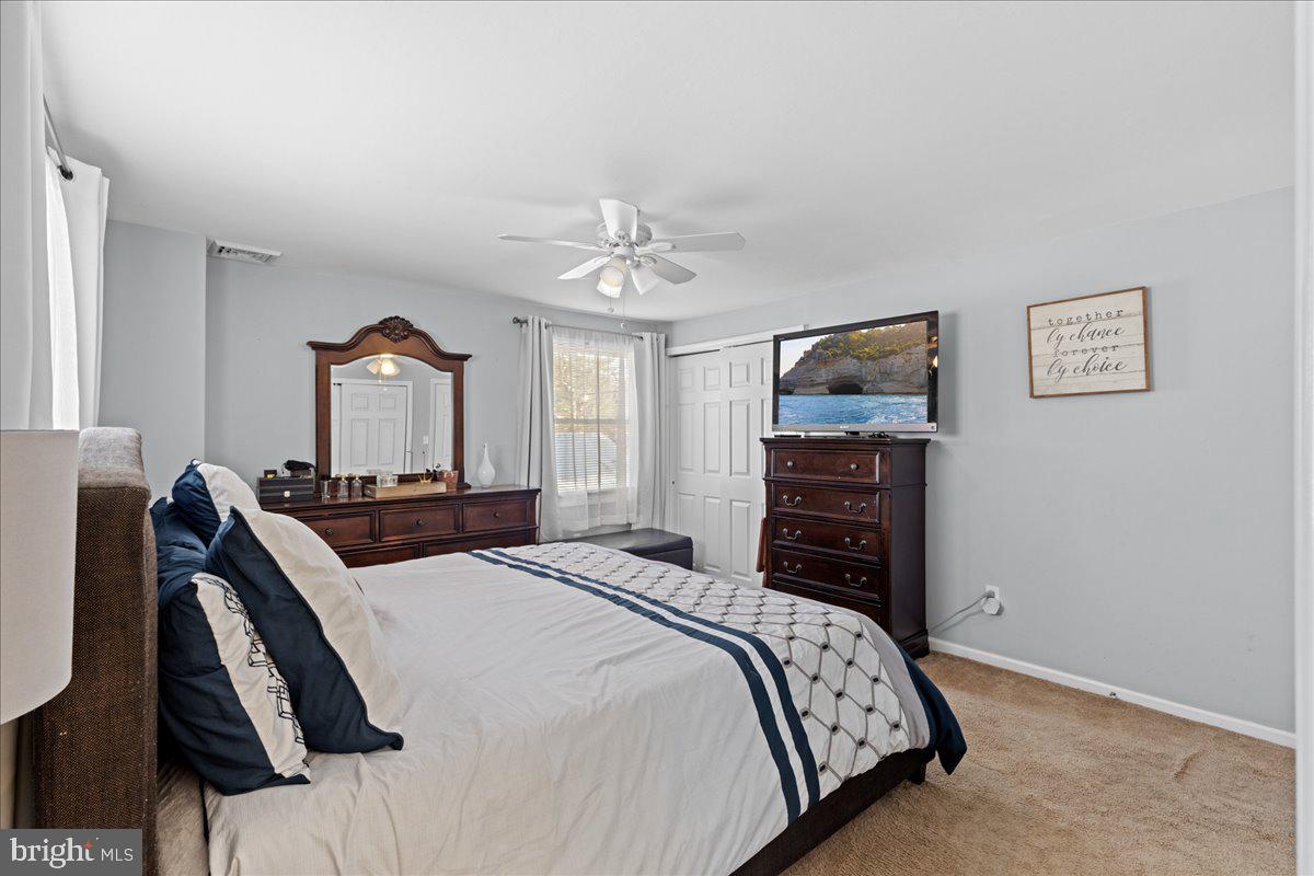142 Pheasant Lane Willingboro, NJ 08046 - Photo 20 of 24 a bedroom with a bed and a chandelier