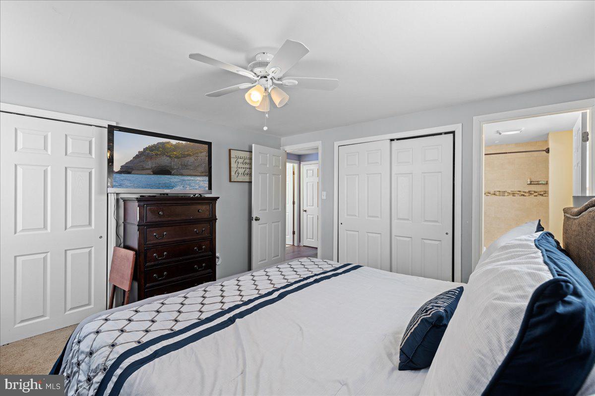 142 Pheasant Lane Willingboro, NJ 08046 - Photo 21 of 24 a bedroom with a bed and a chandelier