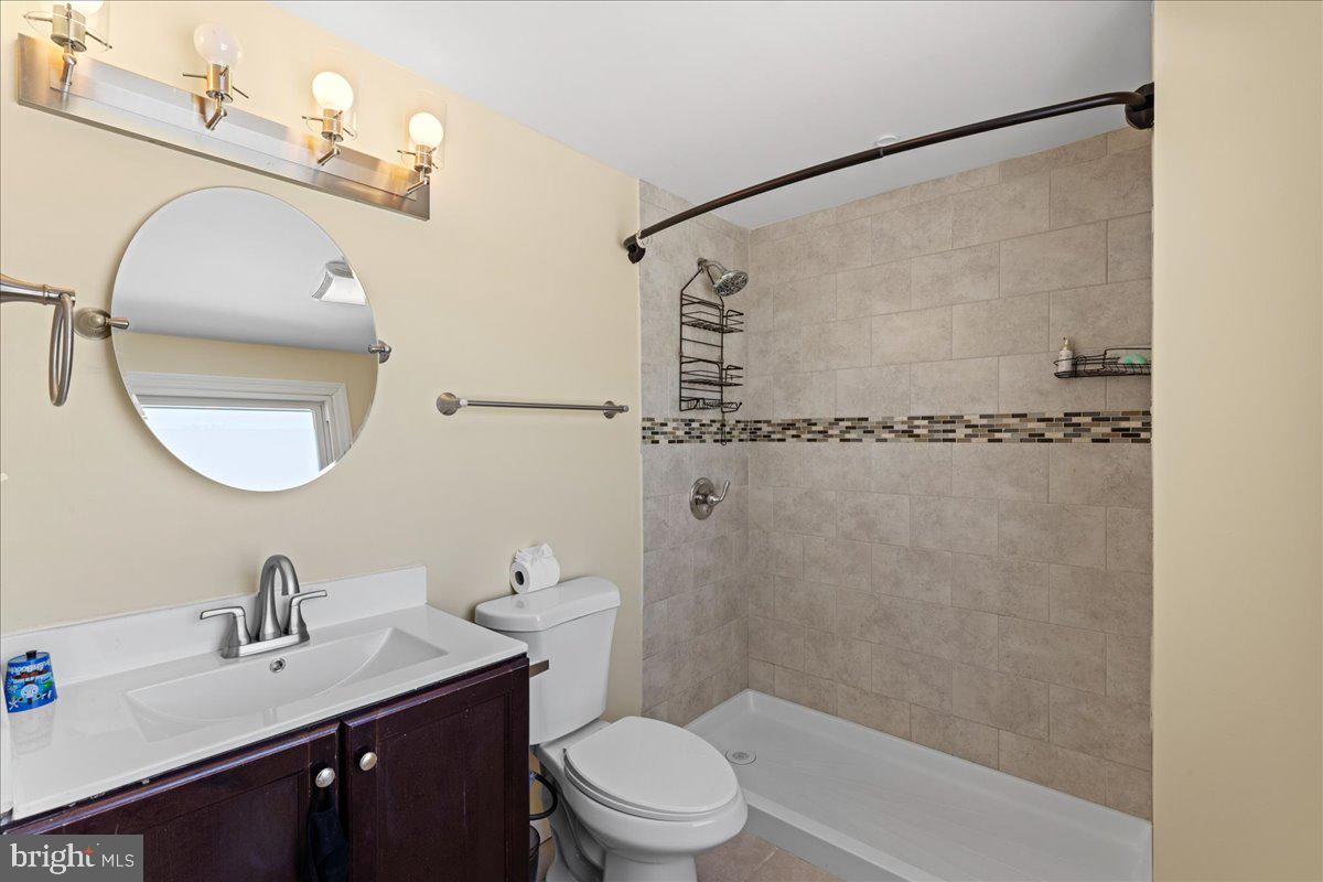 142 Pheasant Lane Willingboro, NJ 08046 - Photo 22 of 24 a bathroom with a sink toilet a mirror and shower
