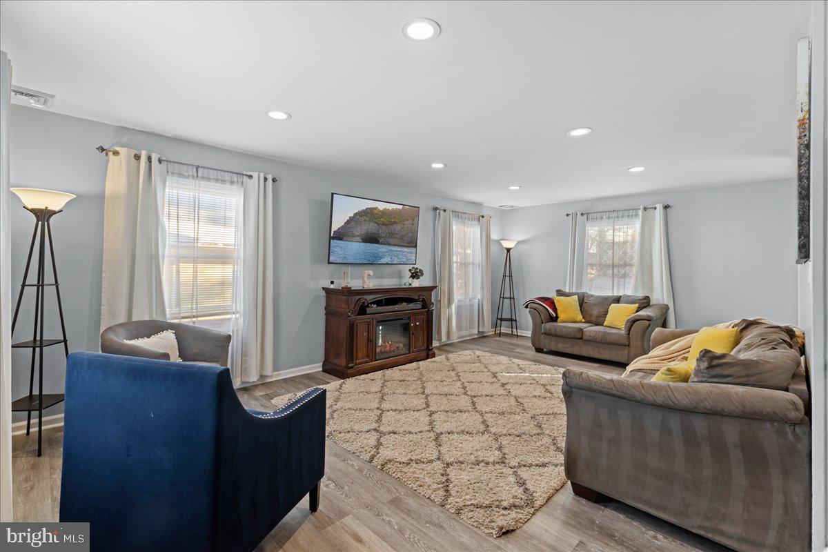 142 Pheasant Lane Willingboro, NJ 08046 - Photo 3 of 24 a living room with furniture a fireplace and a flat screen tv