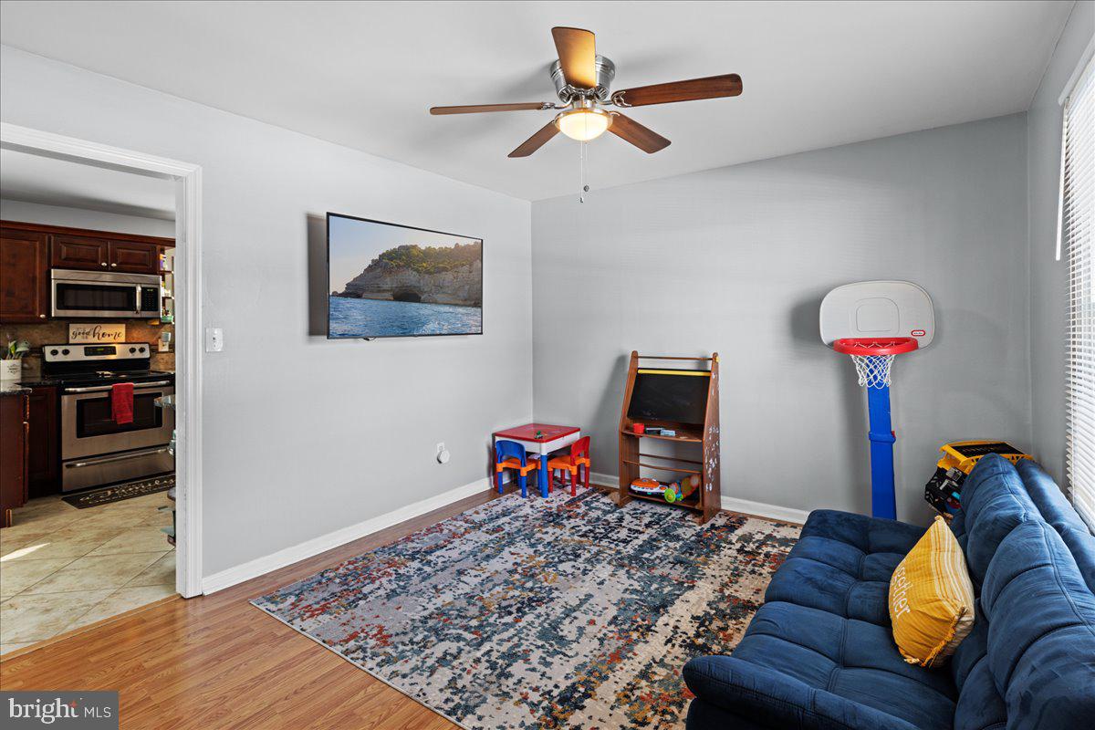 142 Pheasant Lane Willingboro, NJ 08046 - Photo 7 of 24 a workspace with furniture and wooden floor