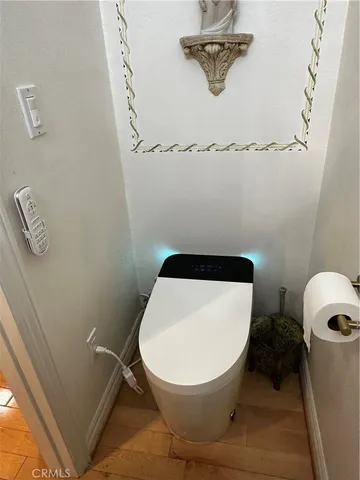 a kitchen with stainless steel appliances granite countertop a refrigerator a stove a sink dishwasher and microwave with wooden floor