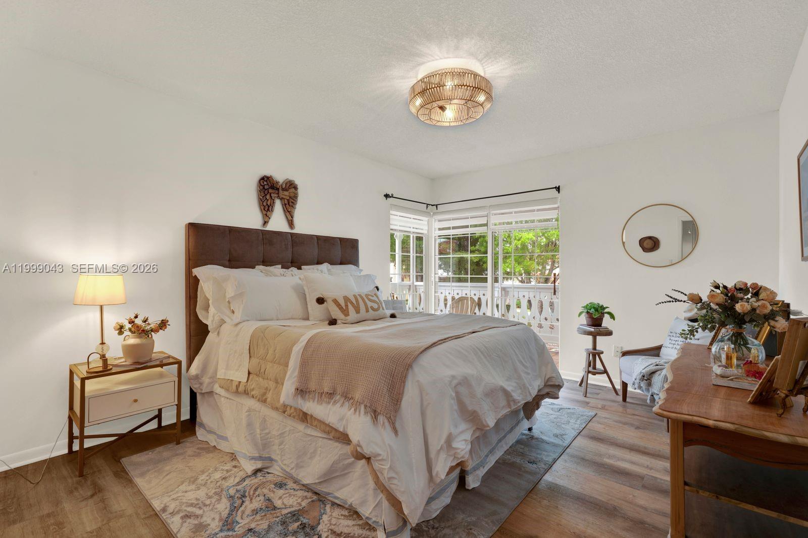 10441 Mahogany Key Circle, Unit 202 Miami, FL 33196 - Photo 12 of 42 a bedroom with a bed and a chandelier