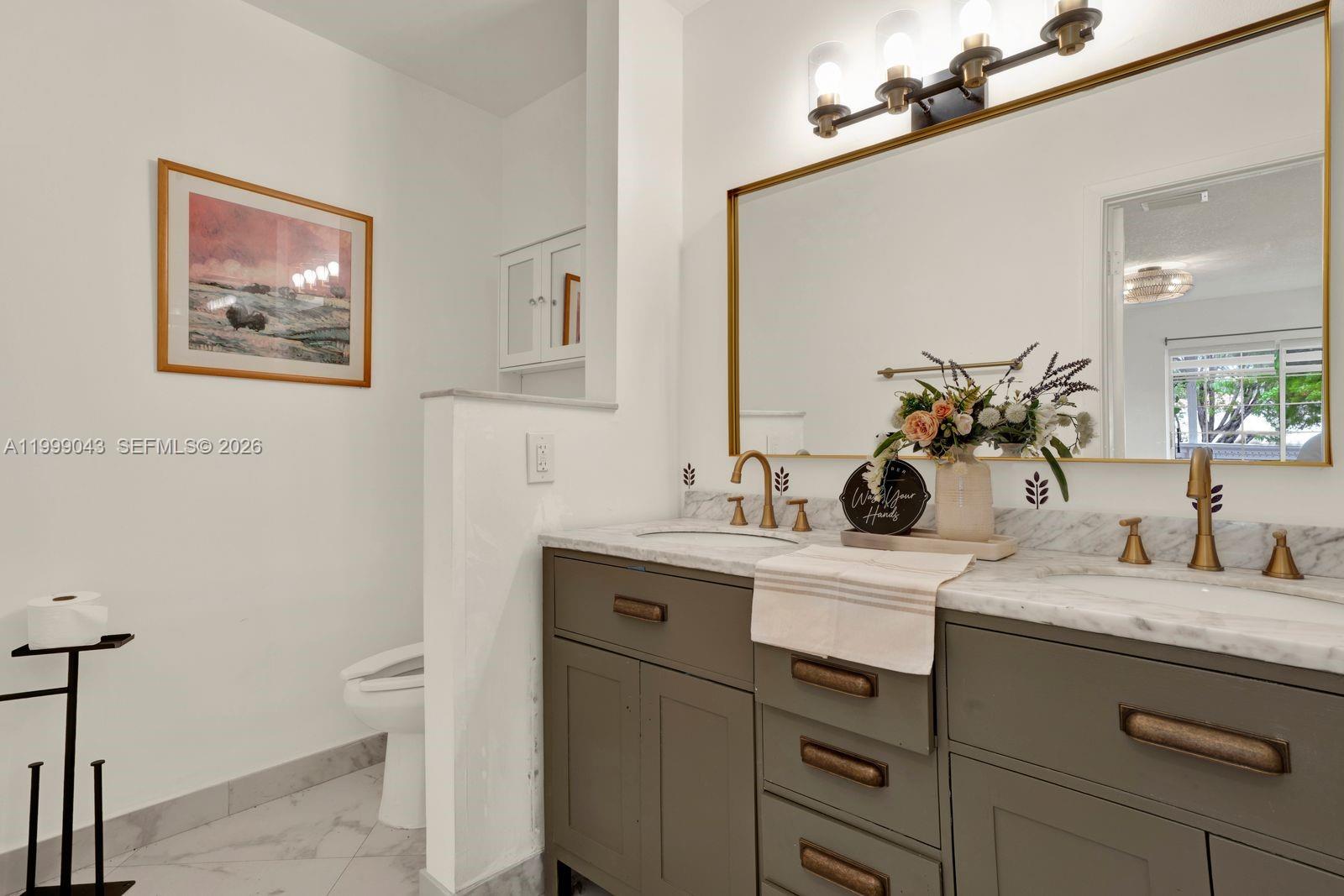 10441 Mahogany Key Circle, Unit 202 Miami, FL 33196 - Photo 16 of 42 a bathroom with a sink and a mirror