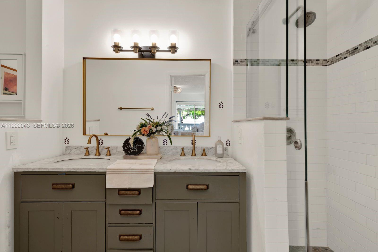 10441 Mahogany Key Circle, Unit 202 Miami, FL 33196 - Photo 17 of 42 a bathroom with a sink vanity and a mirror