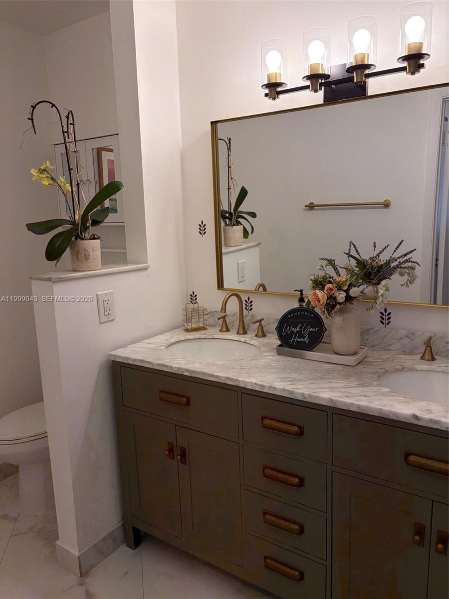 10441 Mahogany Key Circle, Unit 202 Miami, FL 33196 - Photo 18 of 42 a bathroom with a sink and a mirror