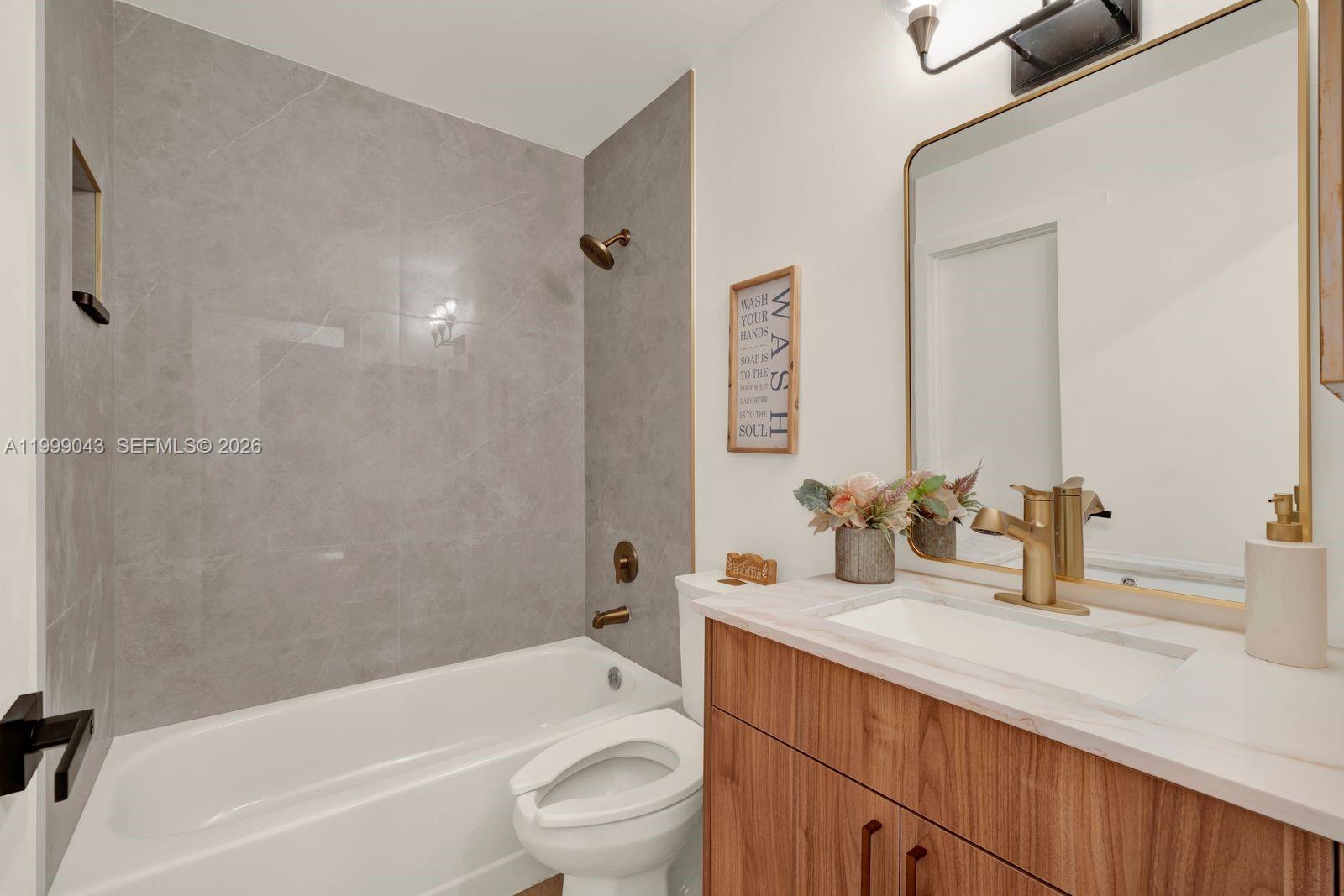 10441 Mahogany Key Circle, Unit 202 Miami, FL 33196 - Photo 23 of 42 a bathroom with a granite countertop bathtub shower sink vanity mirror and toilet