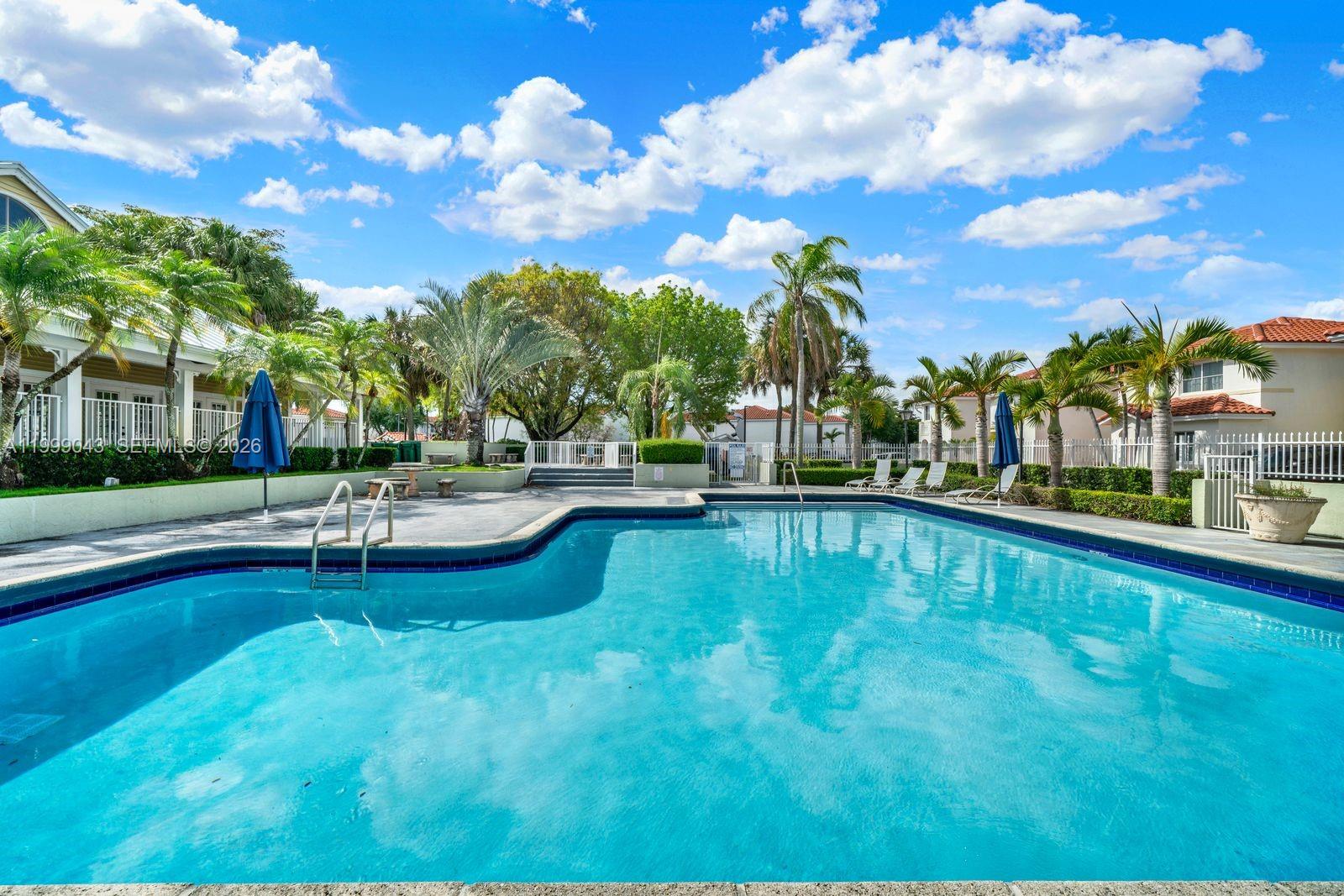 10441 Mahogany Key Circle, Unit 202 Miami, FL 33196 - Photo 34 of 42 a swimming pool with outdoor seating and yard