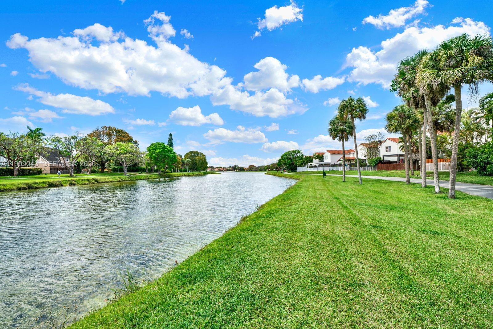 10441 Mahogany Key Circle, Unit 202 Miami, FL 33196 - Photo 35 of 42 a view of a lake with houses in the back