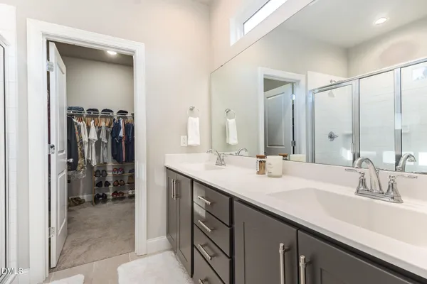 a bathroom with a double vanity sink a and mirror