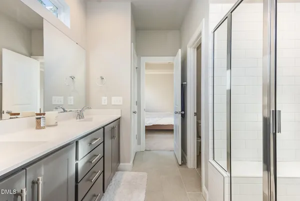 a bathroom with a double vanity sink and a mirror