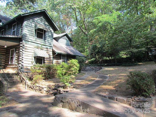 3465 Lynn Road Tryon, NC 28782 - Photo 2 of 31 a front view of house with yard and trees in the background