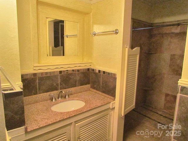 3465 Lynn Road Tryon, NC 28782 - Photo 21 of 31 a bathroom with a granite countertop sink and a mirror