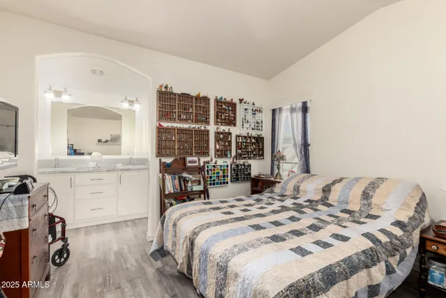 a bedroom with a bed and a large window