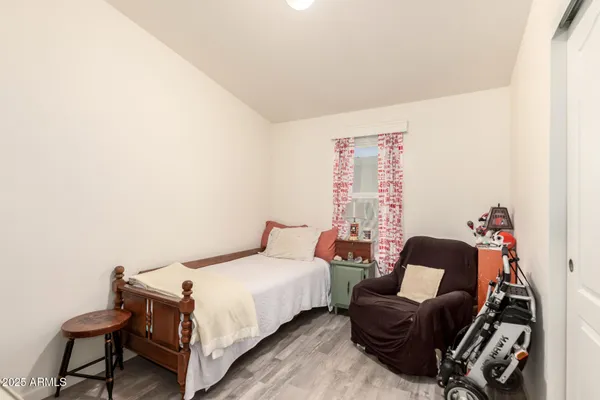 a bedroom with a bed and a chair
