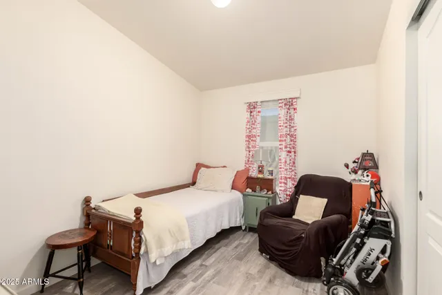 a bedroom with a bed and a chair